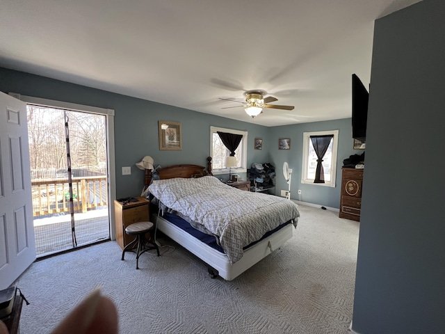 bedroom with access to exterior, light colored carpet, baseboards, and a ceiling fan