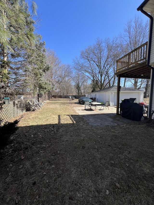 view of yard with an outbuilding, fence private yard, and a patio area