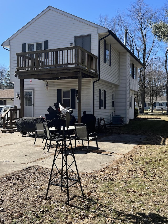 rear view of house featuring central air condition unit and a patio