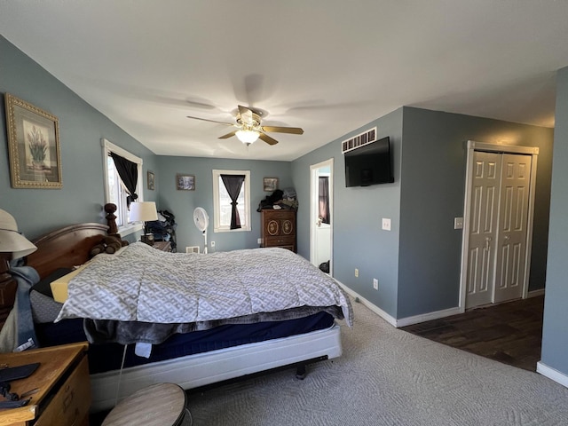 bedroom featuring a closet, baseboards, carpet floors, and a ceiling fan