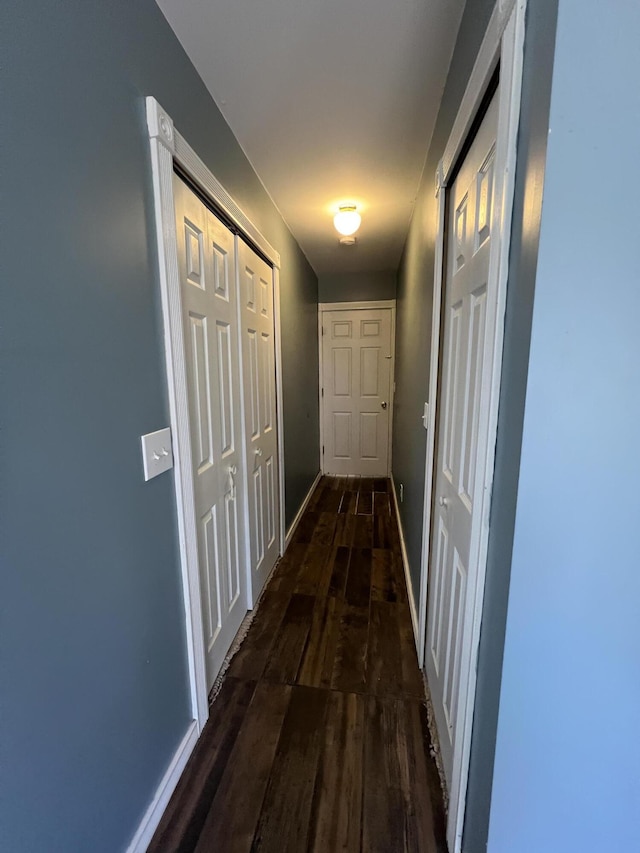 hallway with wood finished floors and baseboards