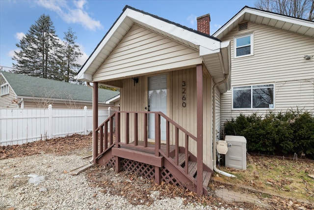 exterior space with a chimney and fence