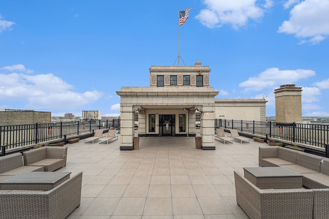 view of patio with an outdoor living space and fence