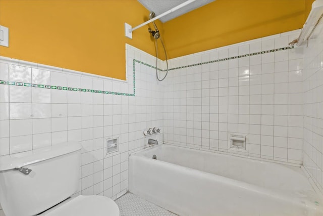 full bath with toilet, tile walls, tile patterned flooring, and shower / tub combination