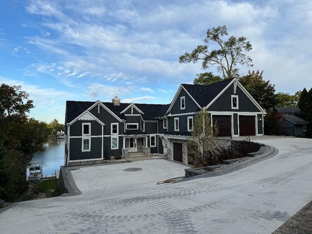 000 Ridge, White Lake, MI 48383 - view of front of property with concrete driveway, board and batten siding, and a garage