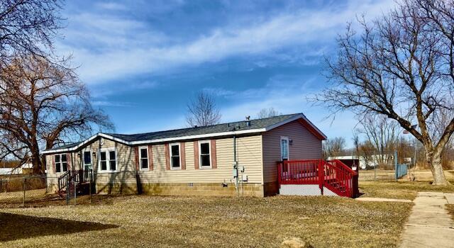 back of house featuring crawl space, a yard, and a wooden deck