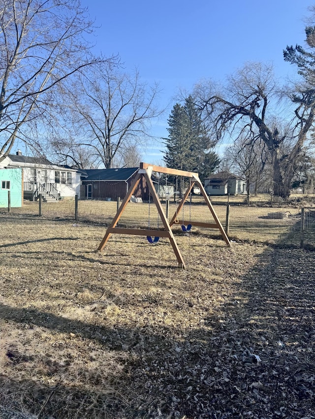 view of yard with a playground and fence