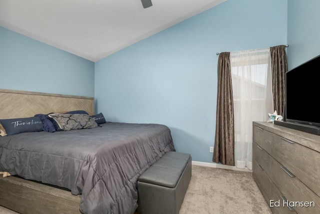 carpeted bedroom with ceiling fan, baseboards, and lofted ceiling