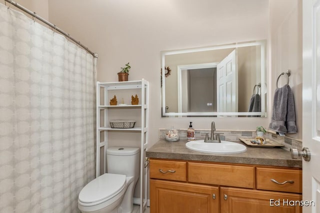 full bathroom with toilet, vanity, and a shower with curtain