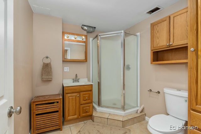 bathroom featuring visible vents, toilet, a stall shower, and vanity