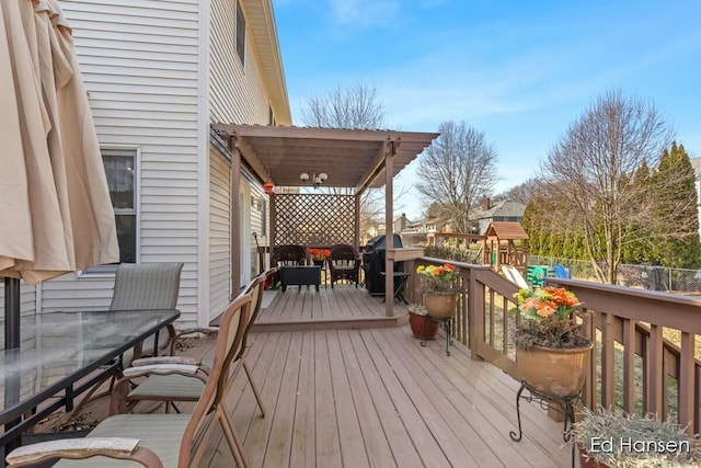 wooden deck featuring a grill