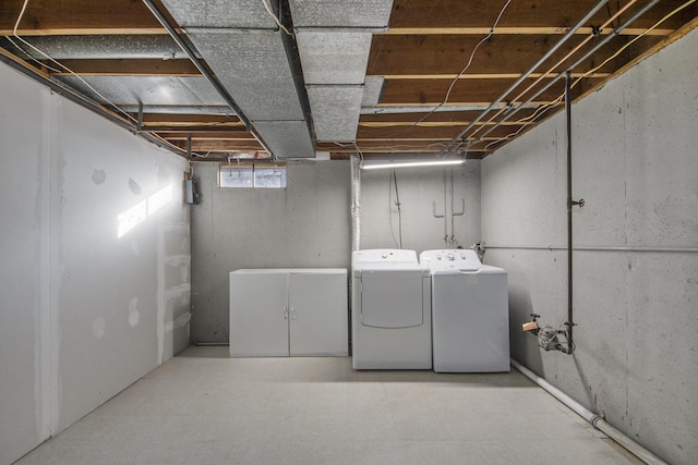 basement featuring washer and clothes dryer and tile patterned floors