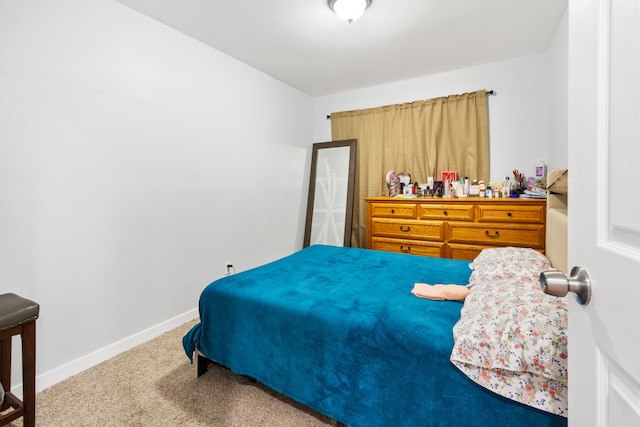 carpeted bedroom featuring baseboards