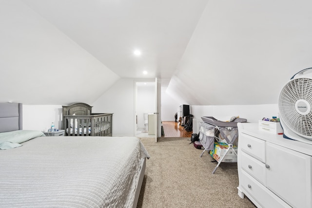 bedroom featuring light carpet and lofted ceiling