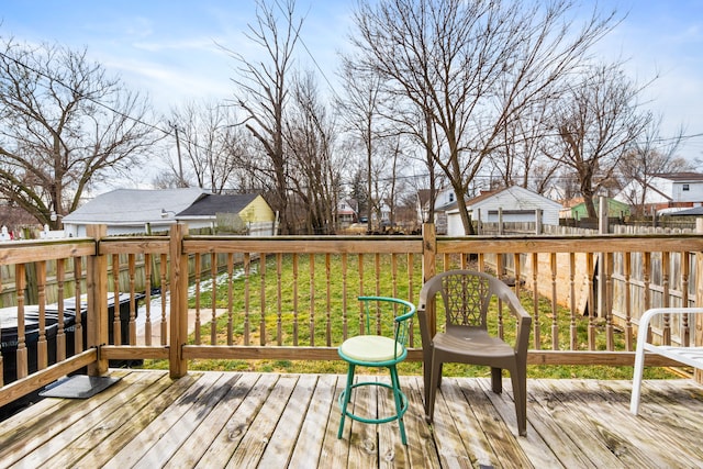 deck with a residential view, a lawn, and fence