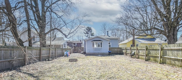 view of yard with a fire pit and a fenced backyard