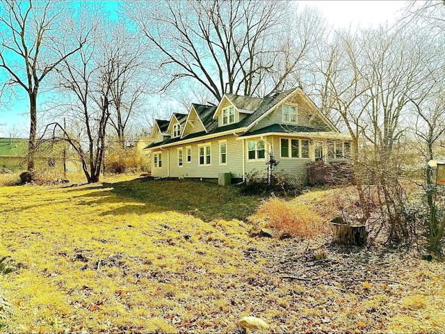 exterior space featuring a yard and cooling unit