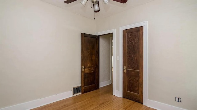 unfurnished bedroom with visible vents, ceiling fan, baseboards, and light wood-style floors