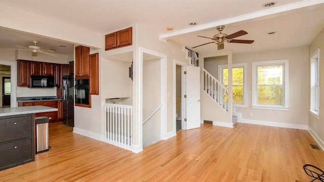 kitchen with black appliances, ceiling fan, and light wood finished floors