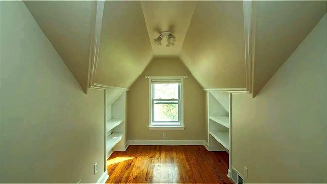 bonus room featuring visible vents, baseboards, lofted ceiling, and wood finished floors