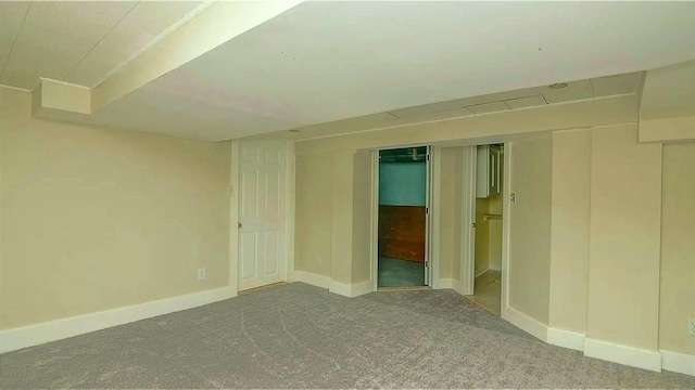 empty room with baseboards and carpet floors