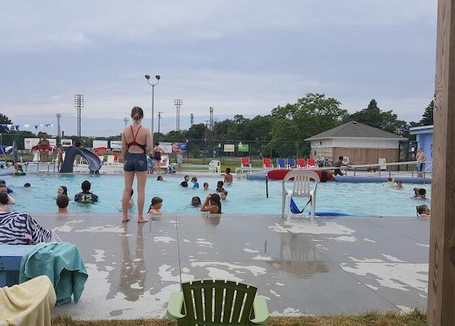 community pool featuring a patio area and fence