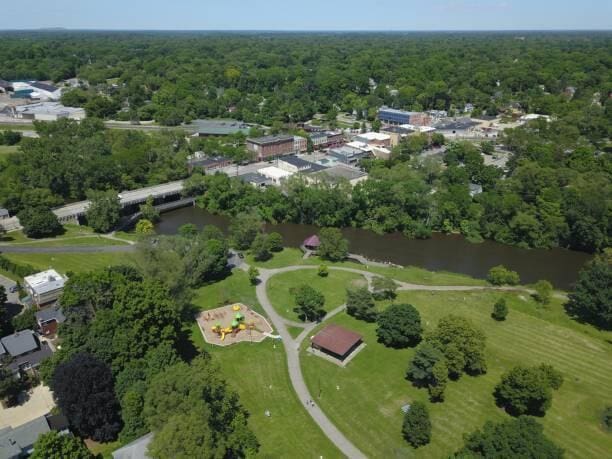 birds eye view of property with a view of trees