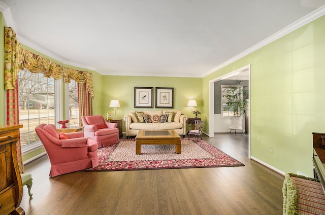 living room featuring crown molding, baseboards, and wood finished floors