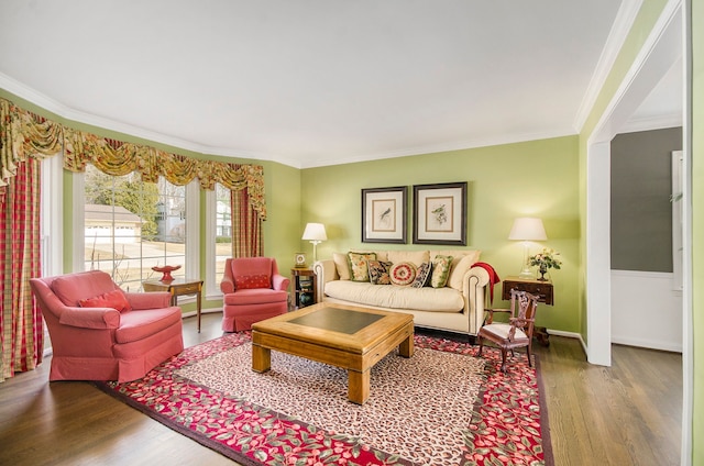 living area with crown molding, baseboards, and wood finished floors