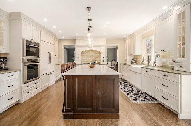 kitchen featuring a sink, white cabinetry, and light countertops