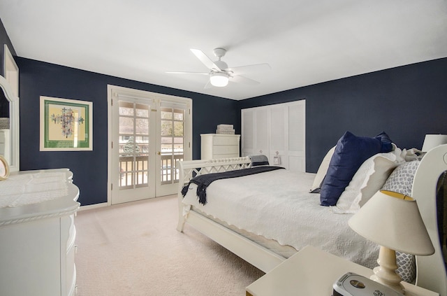 carpeted bedroom featuring baseboards, french doors, a closet, a ceiling fan, and access to outside