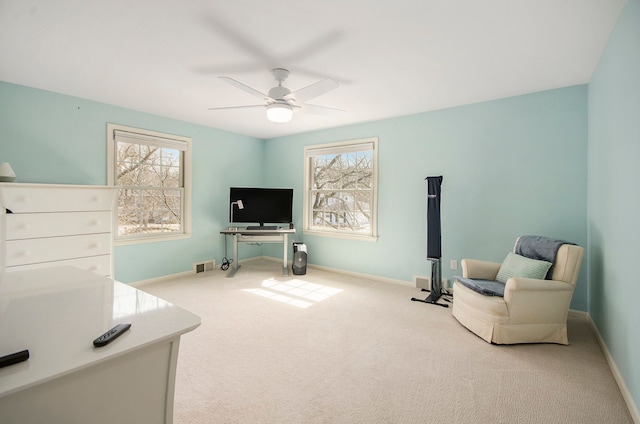 sitting room with carpet flooring, baseboards, a wealth of natural light, and ceiling fan