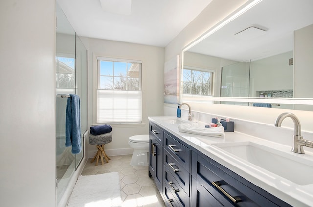 full bathroom featuring tile patterned floors, a shower stall, toilet, and a sink