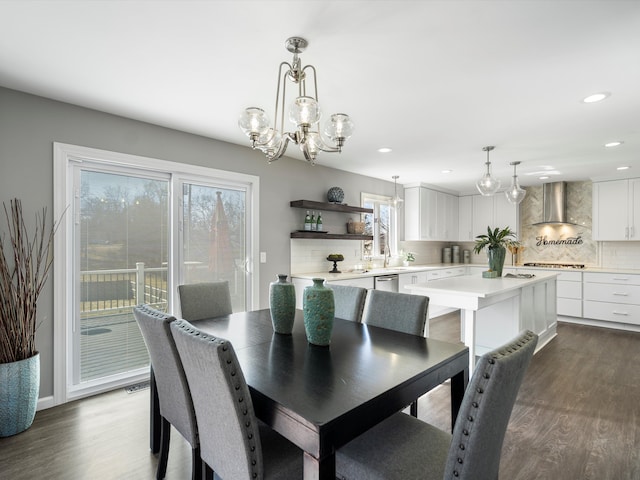 dining room with a notable chandelier, recessed lighting, and dark wood-style flooring