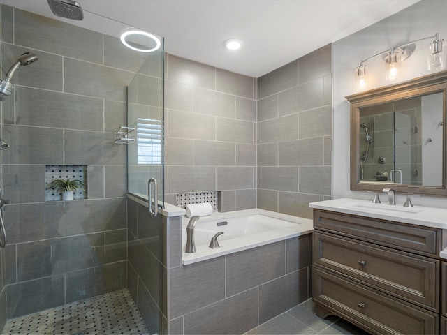 bathroom with tile patterned floors, vanity, a bath, and a shower stall