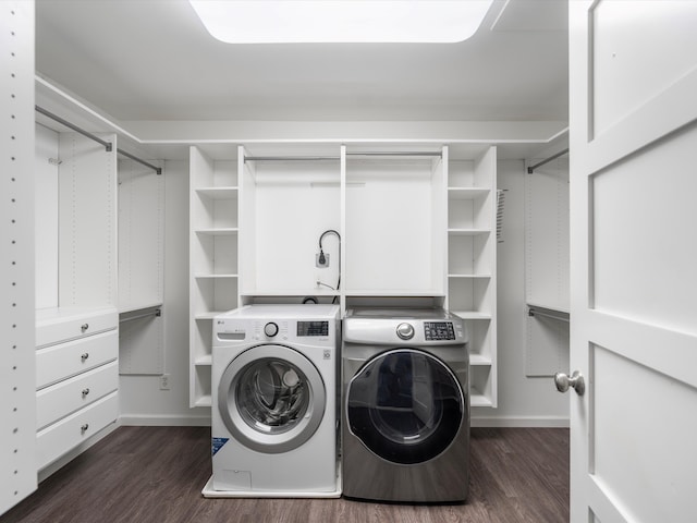 clothes washing area featuring independent washer and dryer, dark wood-style floors, and laundry area