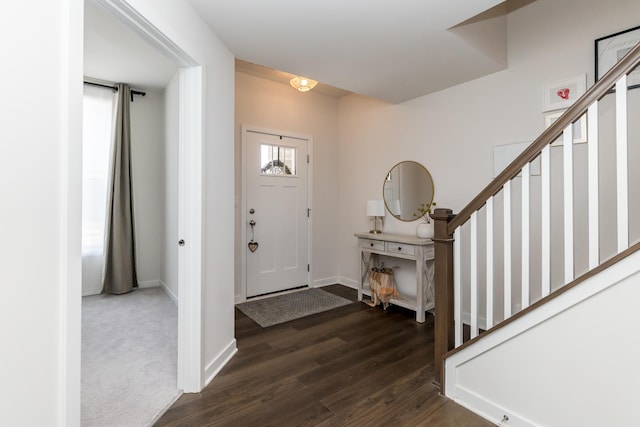 entrance foyer featuring dark wood-style floors, stairway, and baseboards