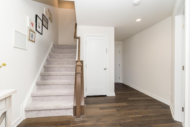 stairs with recessed lighting, baseboards, and wood finished floors