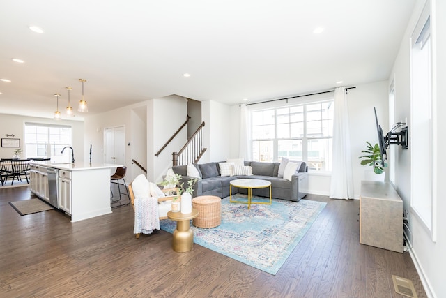 living area featuring visible vents, baseboards, recessed lighting, stairs, and dark wood-type flooring