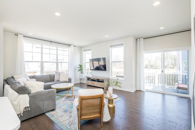 living room featuring a wealth of natural light, dark wood-style floors, and recessed lighting