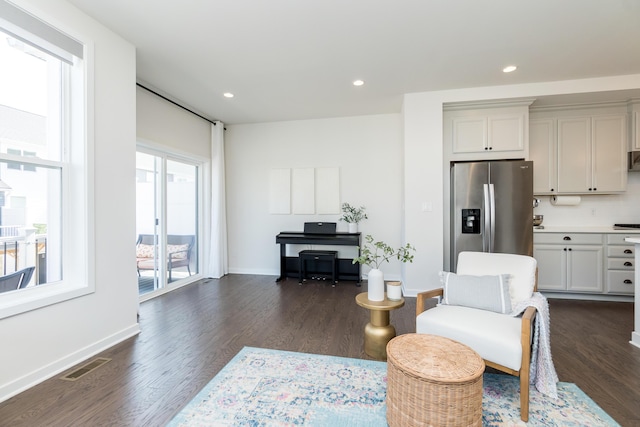 living area with dark wood-type flooring, recessed lighting, and visible vents