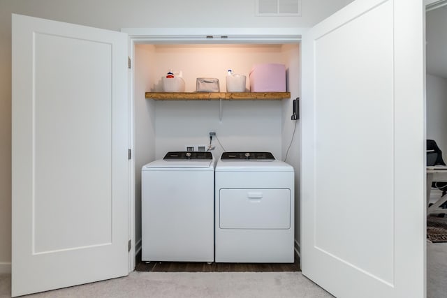 laundry room with laundry area, visible vents, and washing machine and clothes dryer