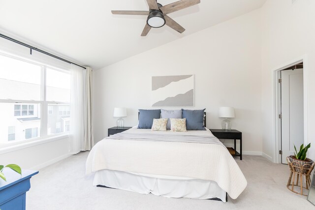 bedroom featuring carpet flooring, ceiling fan, baseboards, and vaulted ceiling