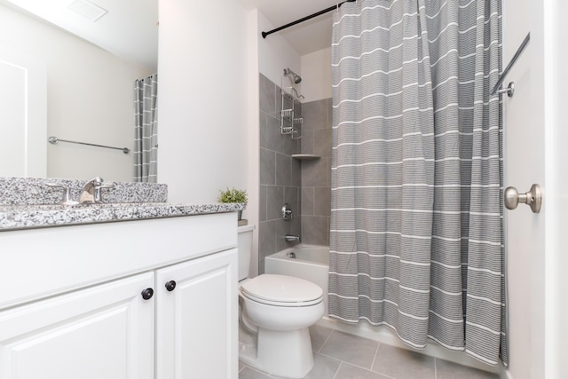 full bath featuring tile patterned flooring, vanity, toilet, and shower / tub combo