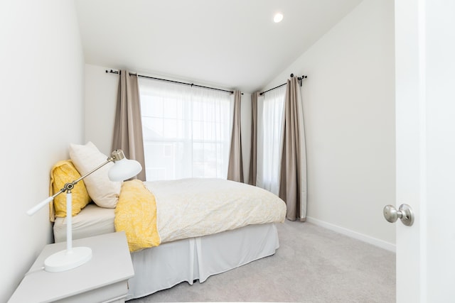 bedroom with lofted ceiling, recessed lighting, baseboards, and light carpet