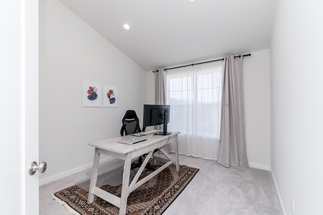 home office featuring lofted ceiling, recessed lighting, baseboards, and light carpet