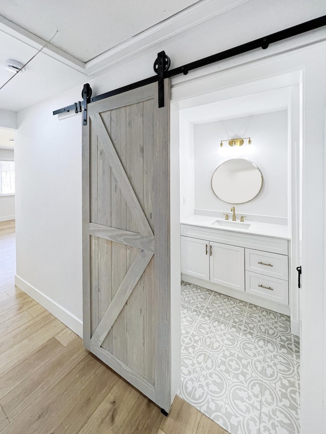 bathroom featuring vanity, baseboards, and wood finished floors