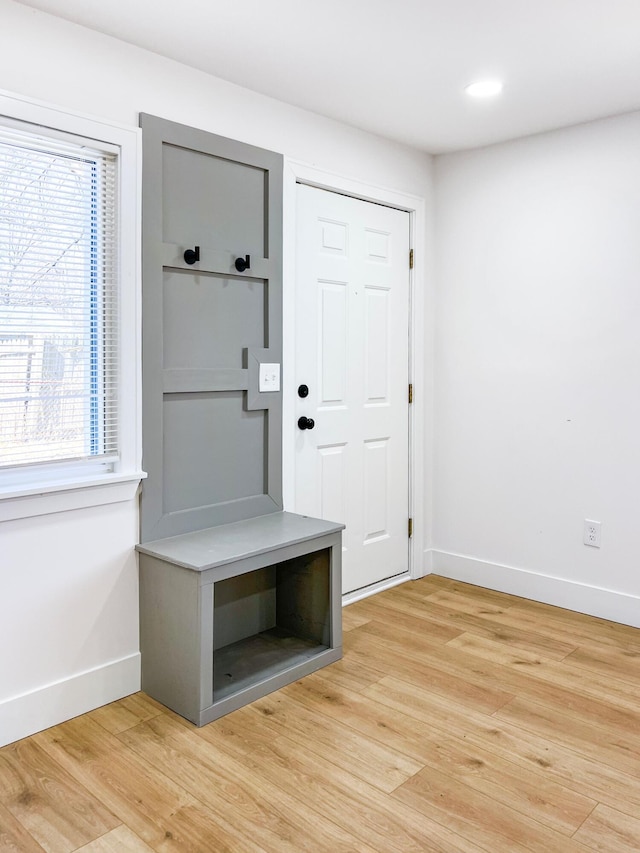 mudroom with baseboards and light wood-style floors