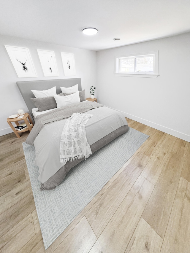 bedroom with baseboards and wood finished floors