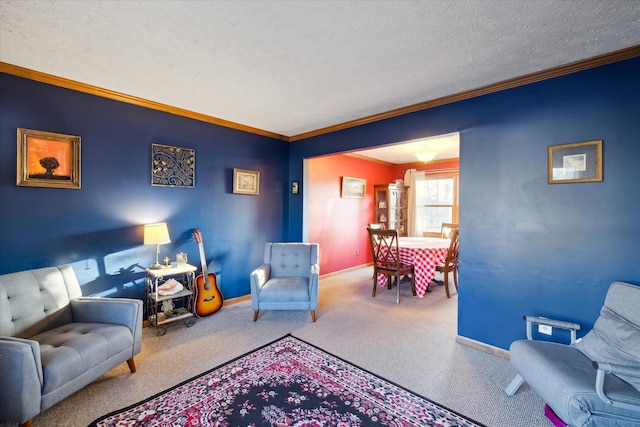 sitting room with a textured ceiling, crown molding, baseboards, and carpet